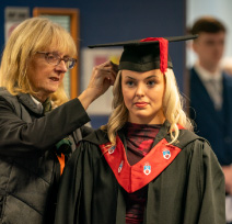 A student getting their robes fitted