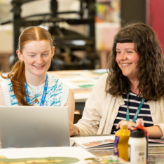 Two students smiling